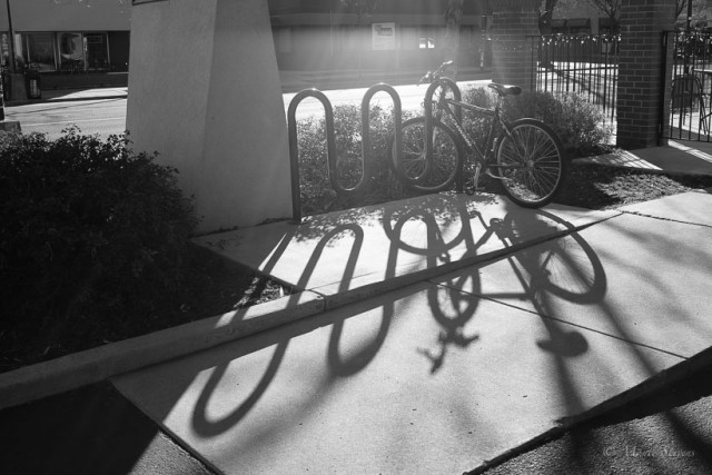 Late afternoon shadows at a bicycle rack