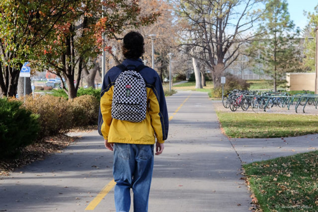 His backpack is checkered 